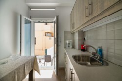 Irini apartments, the kitchen and the side entrance