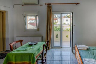 The room 4 view towards the balcony and the village in Kamilari apartments